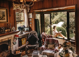 woman sitting on window inside room