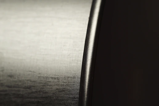 Close-up of a shiny aluminum sheet with brushed texture reflecting soft light