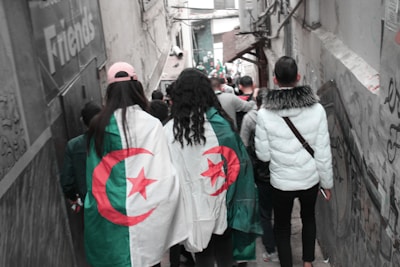 A group of travelers exploring a vibrant Algerian market with local guides.