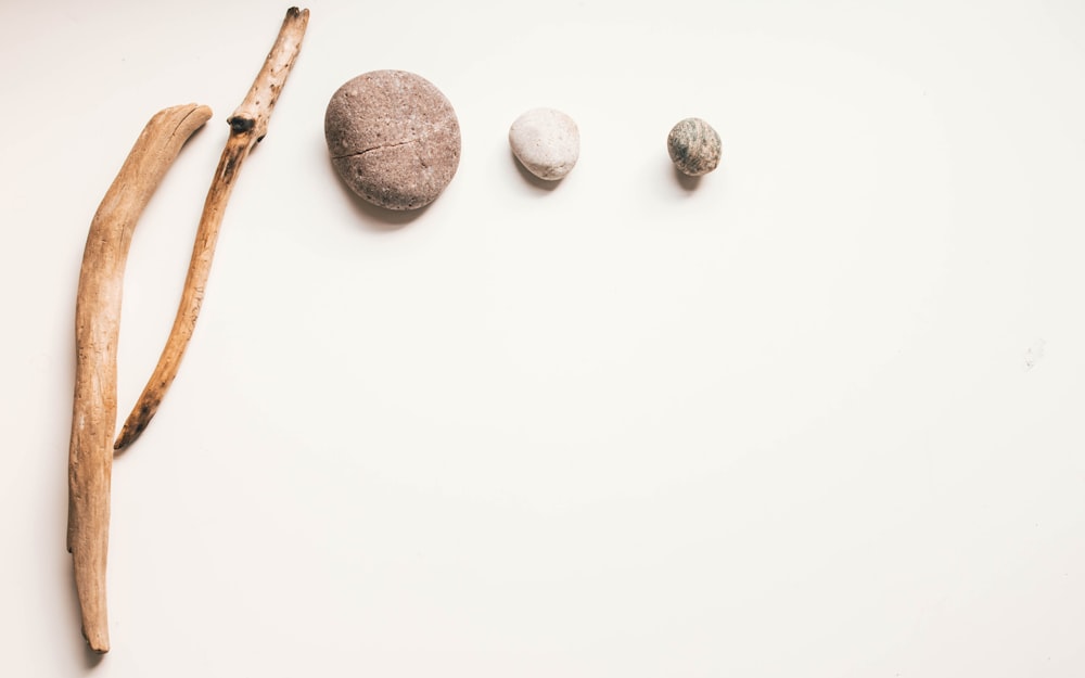 three brown stones on white surface