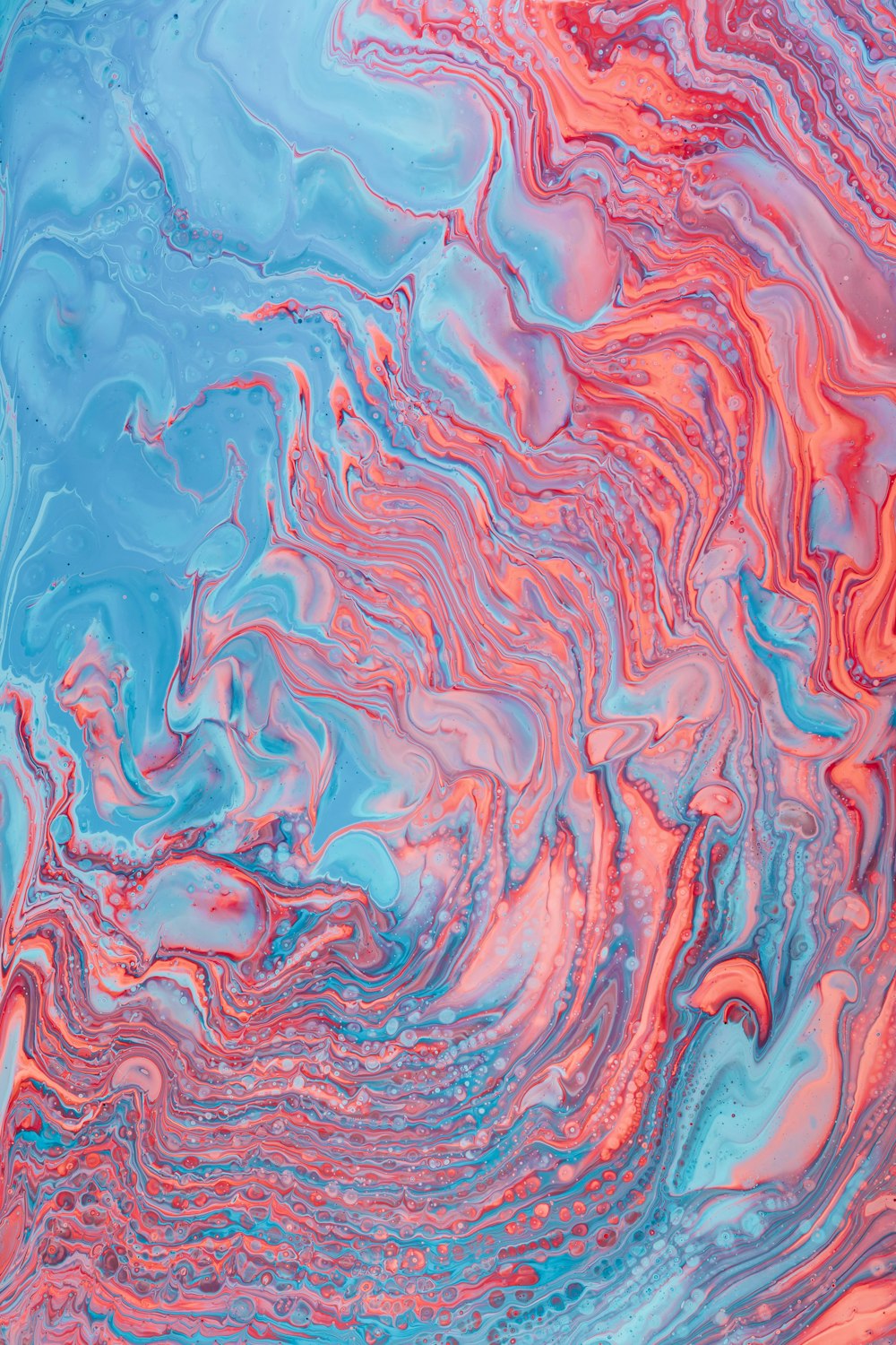 a blue, pink and red liquid swirl background