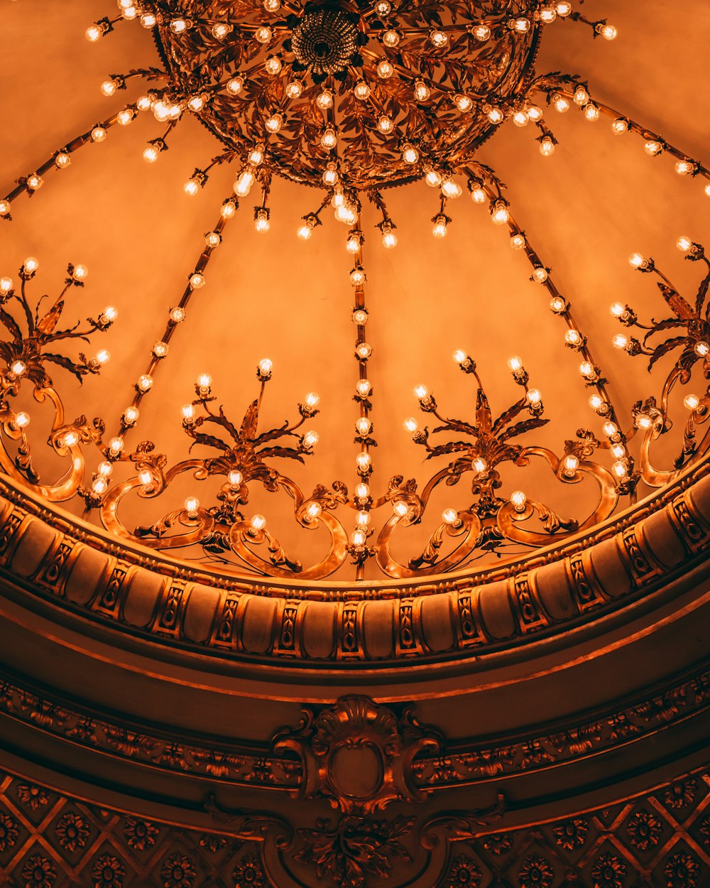 a chandelier in the middle of a domed room