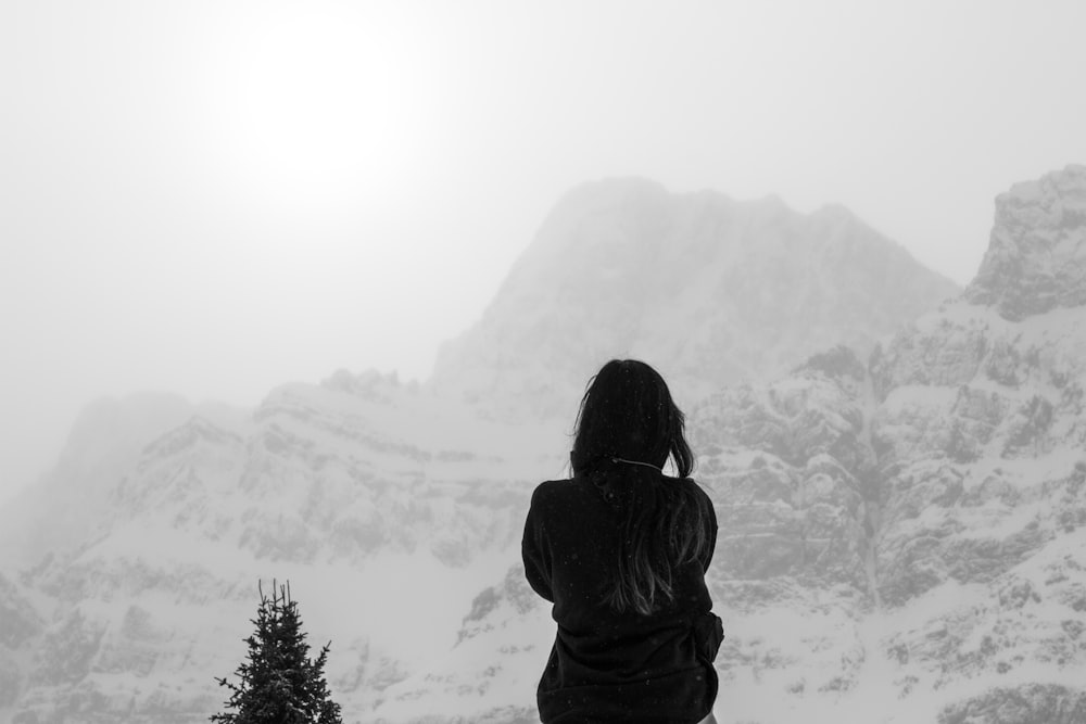 woman standing on top mountain