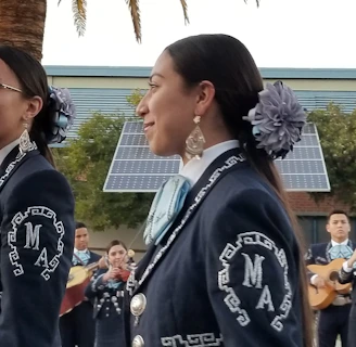 A group of Mexican musicians playing traditional instruments at an outdoor festival in Sydney.