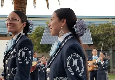 A group of Mexican musicians playing traditional instruments at an outdoor festival in Sydney.