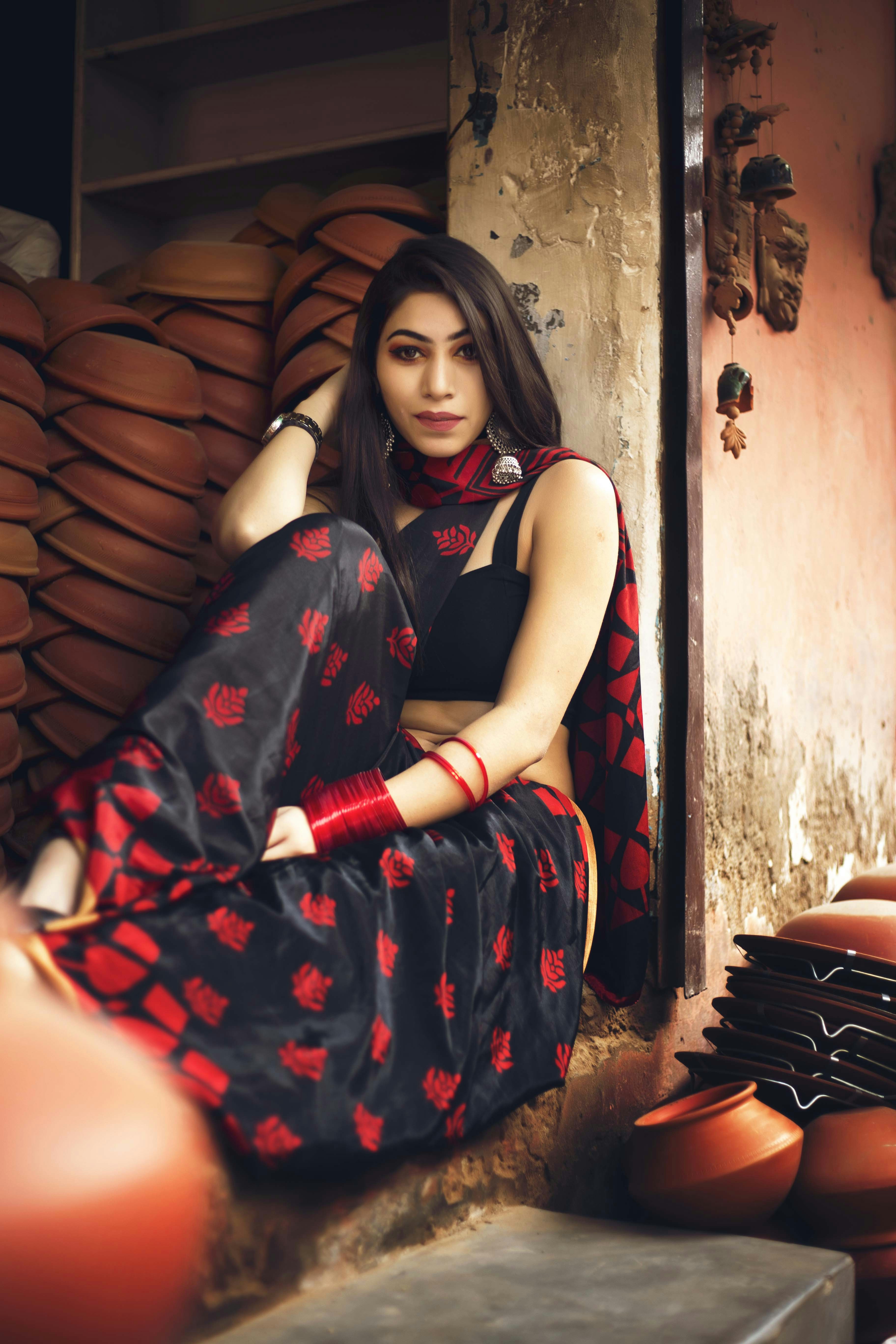 Woman in handwoven earthen-tone Khadi saree, warm natural light, traditional draping