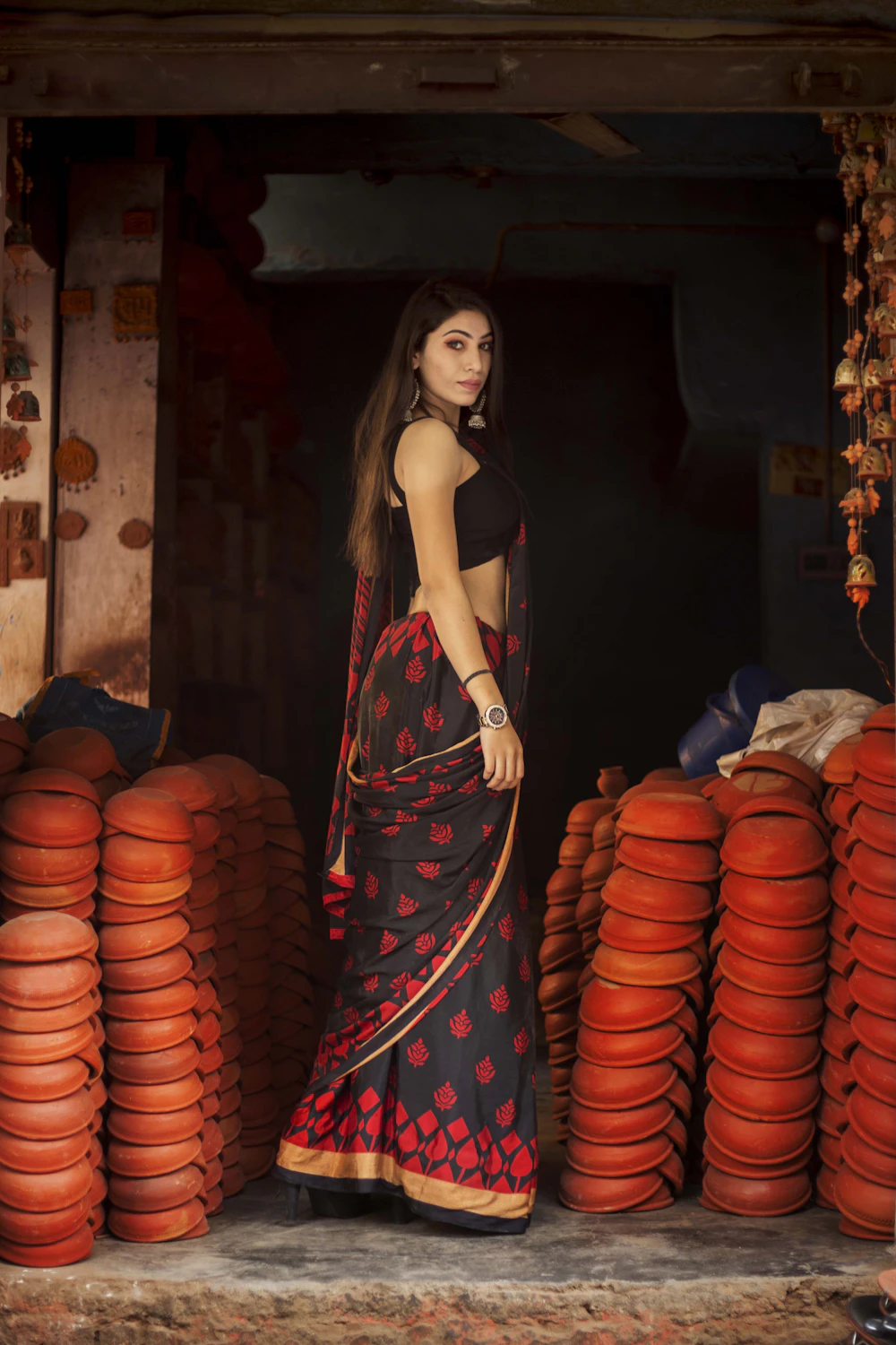 Model surrounded by clay pots