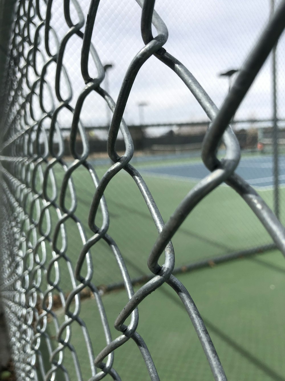 gray cyclone fence selective photography