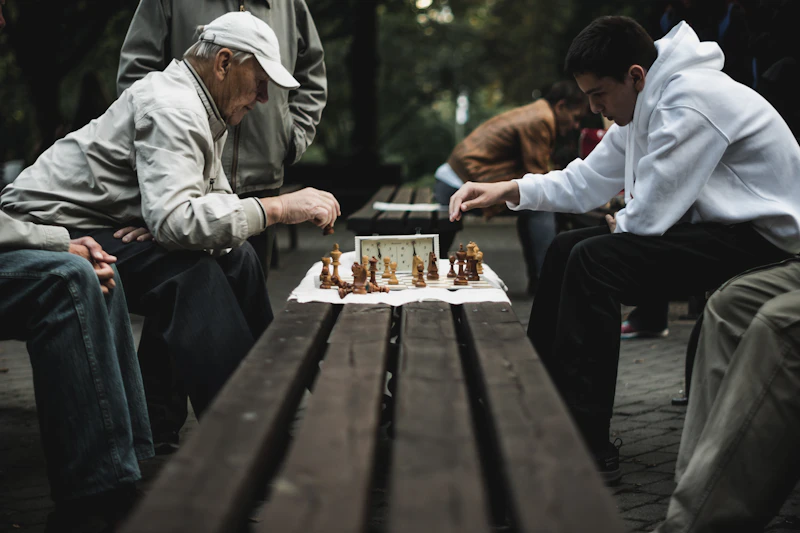 Two people playing chess, representing winning and losing