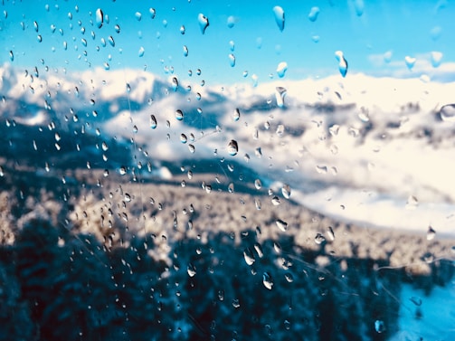 Close-up of sparkling clean windows reflecting alpine scenery on a bright winter day.