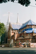 Wide shot of scaffolding erected around a historic stone church.
