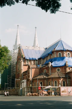 Wide shot of scaffolding erected around a historic stone church.