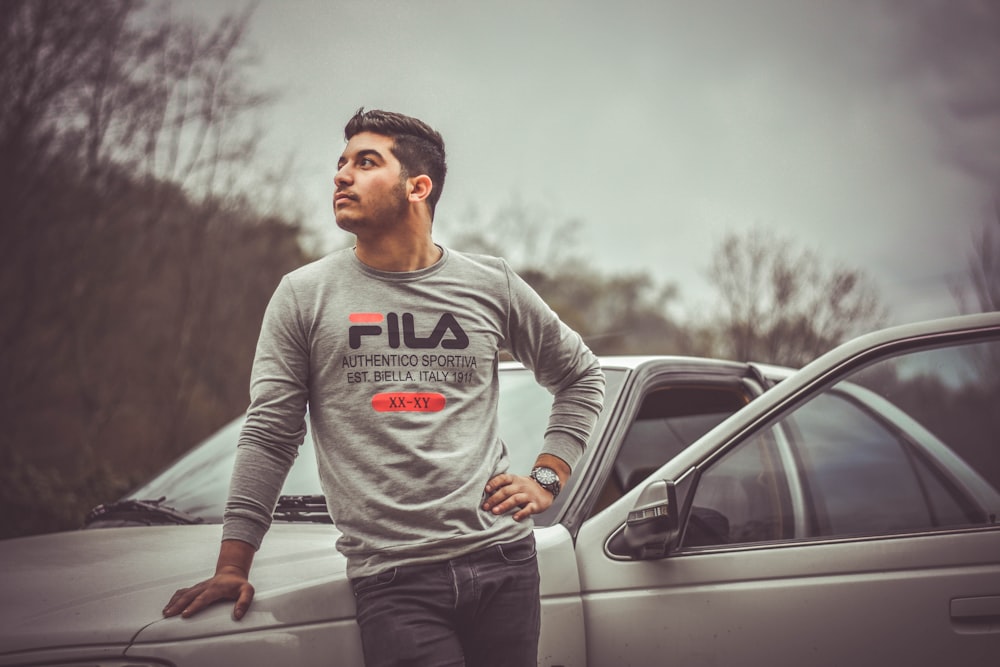 man leaning on car