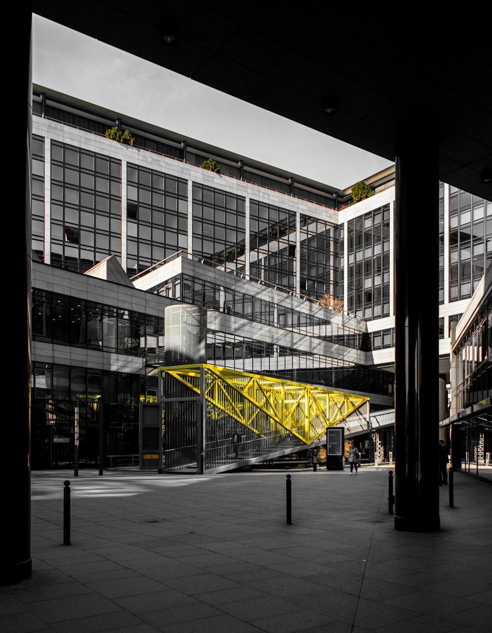 person walking beside gray stair during daytime