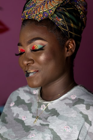 Close-up of a woman showcasing a chic, modern headwrap with subtle purple accents.