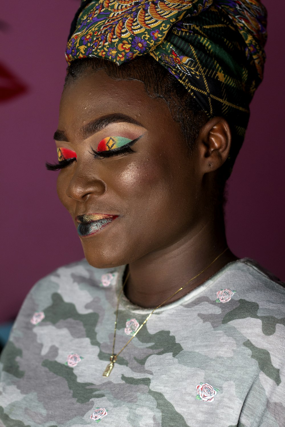 smiling woman with multicolored eyeshadow