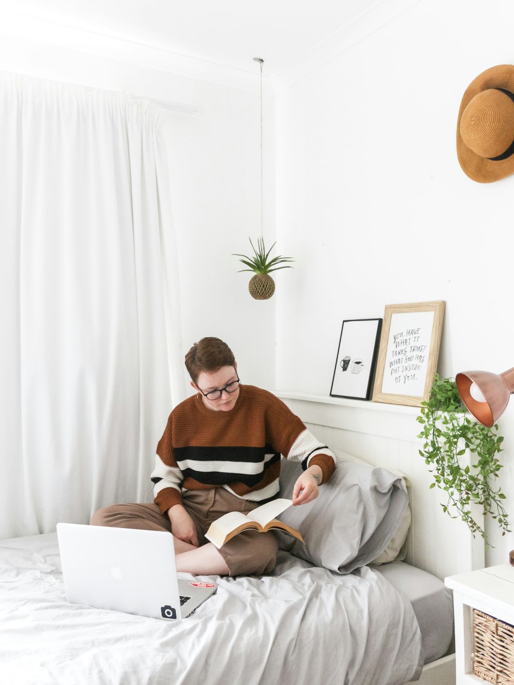 woman sitting on bed inside room