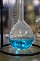 Magnetic stirrer mixing solutions with bright blue lab environment.