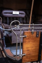 Close-up of traditional brass fittings and reins on a restored coach.