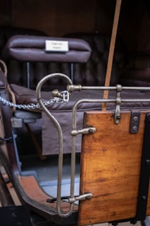 Close-up of traditional brass fittings and reins on a restored coach.