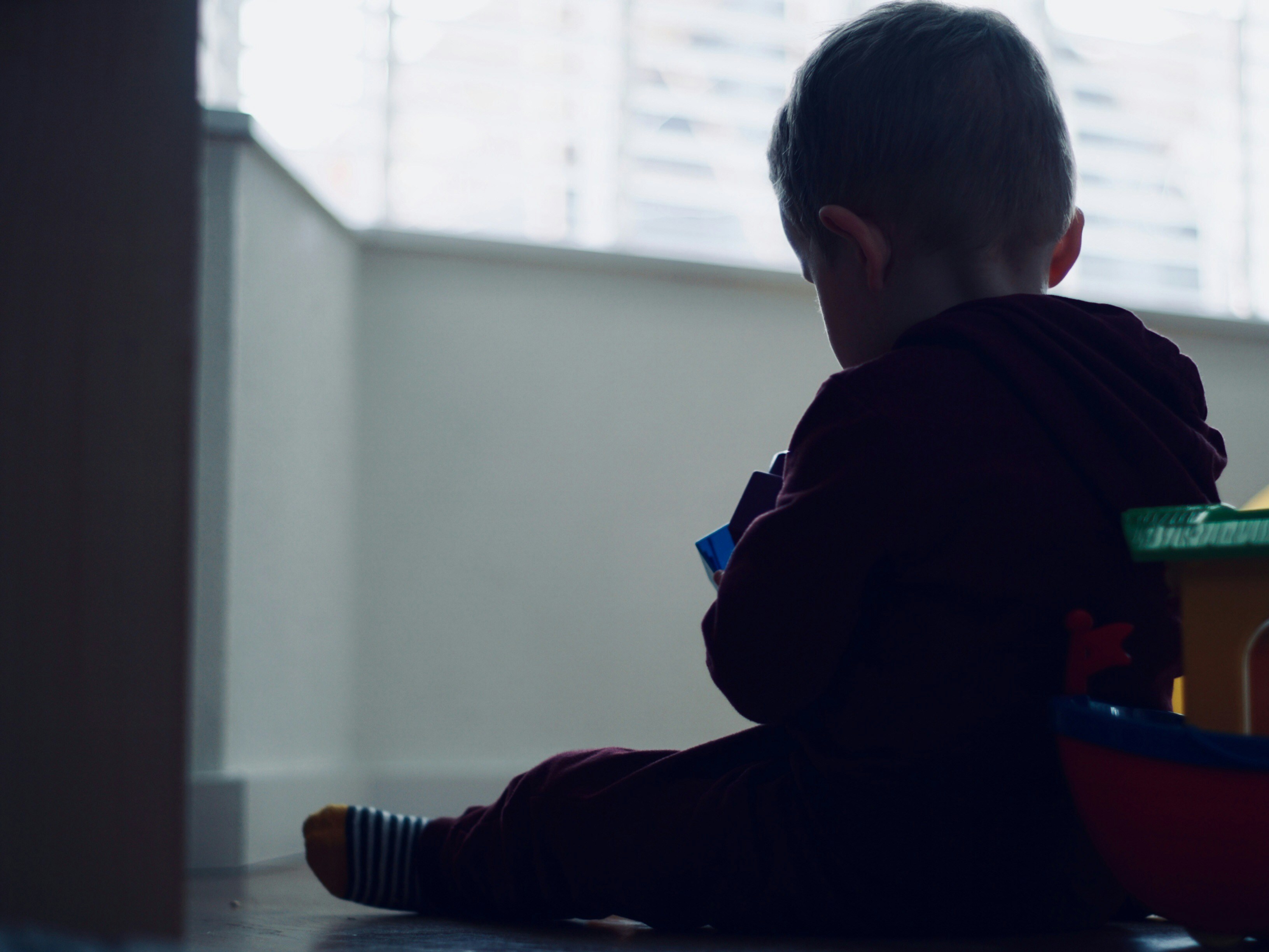 toddler sitting on floor inside room