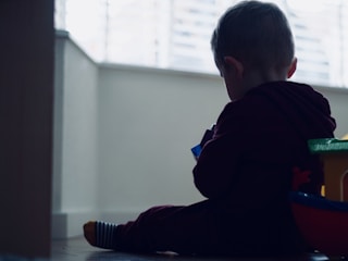 Children playing with colorful toys in a bright room.