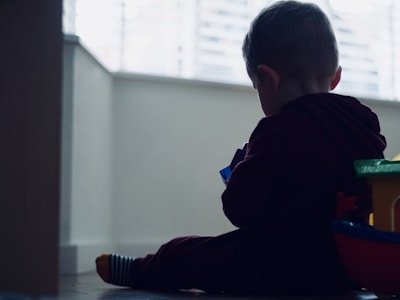 A joyful child playing with colorful, safe toys in a cozy, sunlit room.