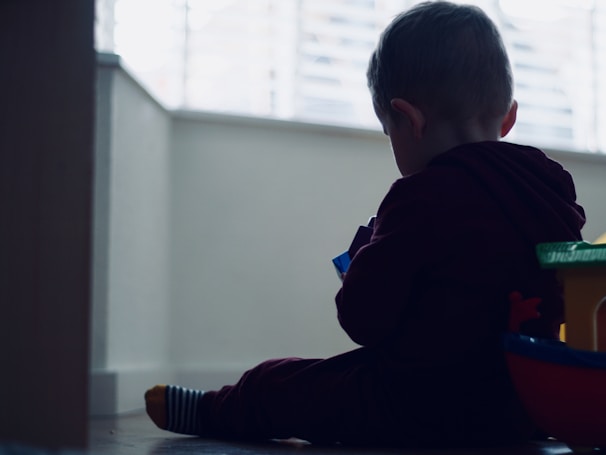A joyful child playing with colorful toys in a bright room.