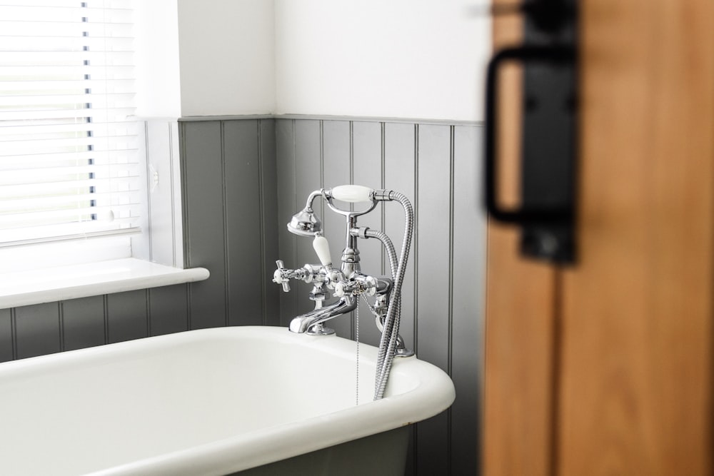 a bathroom with a claw foot tub and a wooden door