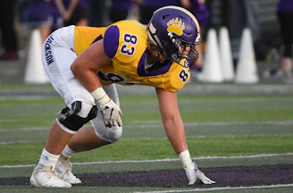 man about to stand in green field