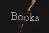 the words books are lit up in the dark