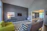 A bright, freshly painted living room showcasing smooth drywall and colorful accents.