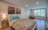 Elegant bedroom featuring turquoise and beige tones with soft, ambient lighting.