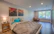 Elegant bedroom featuring turquoise and beige tones with soft, ambient lighting.
