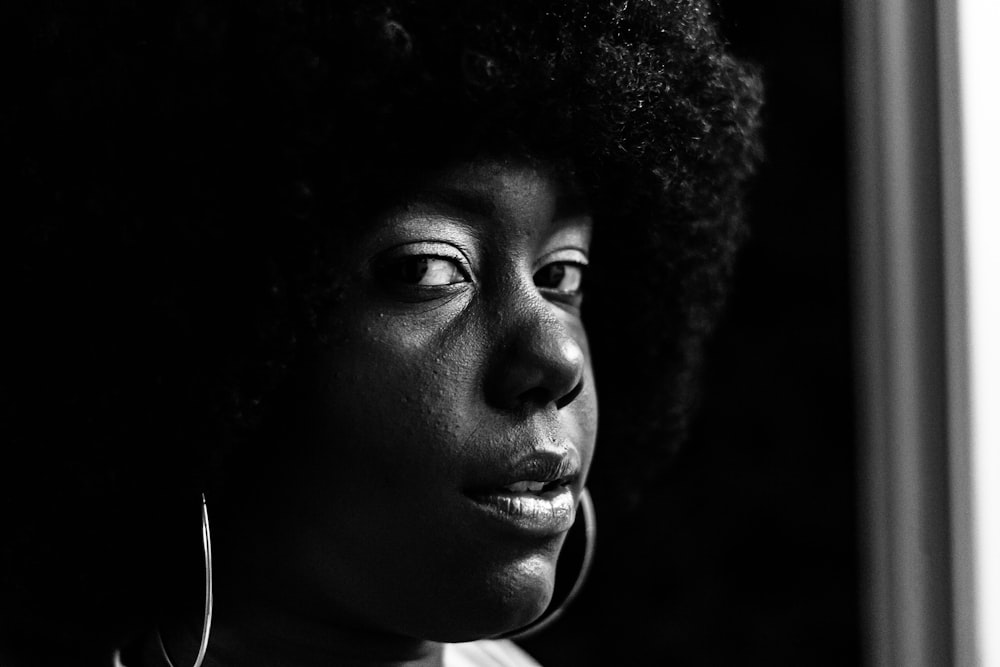 grayscale photo of woman with curly hair