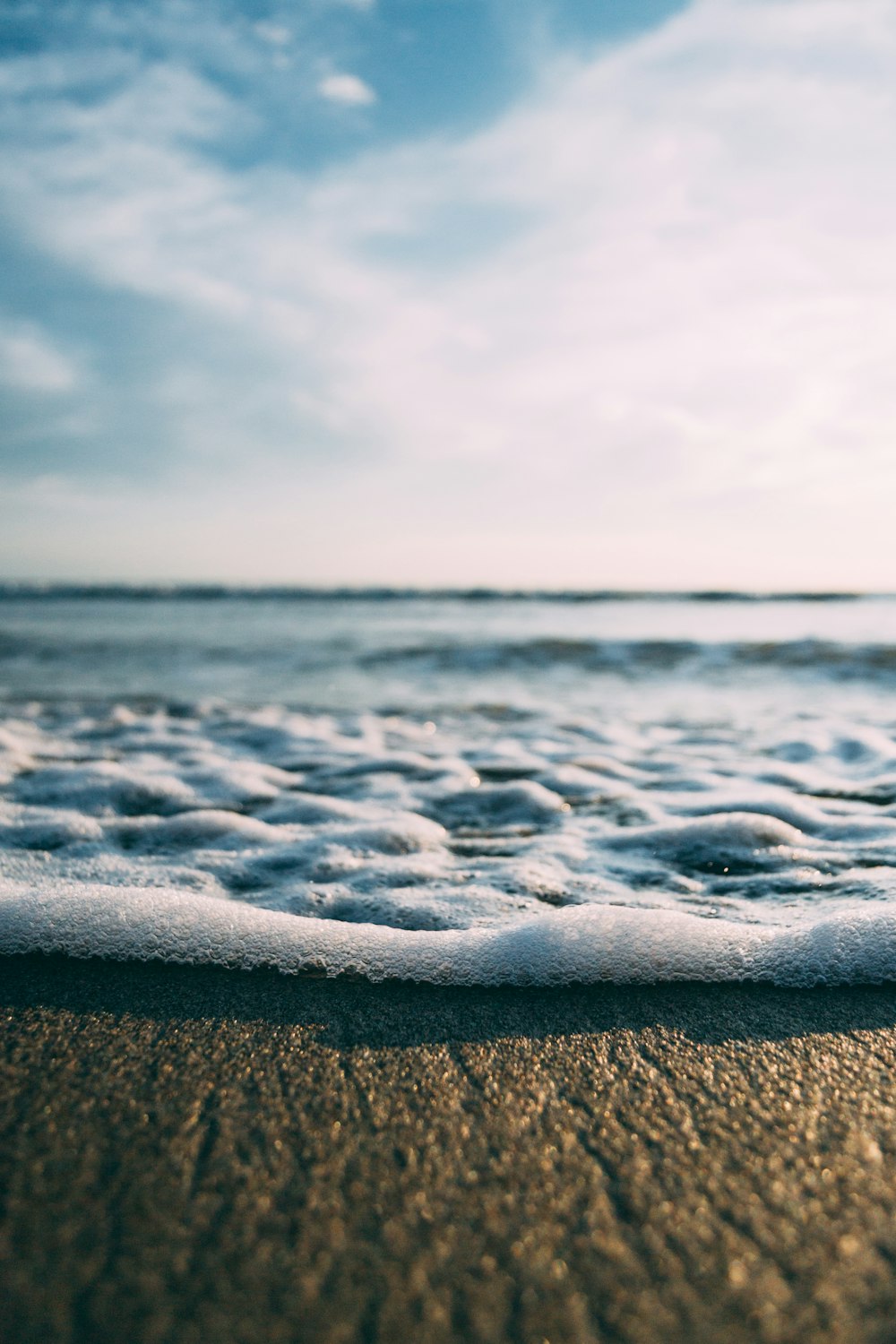 sea foam during daytime