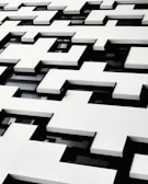 Elegant residential facade with geometric shapes and subtle beige accents.