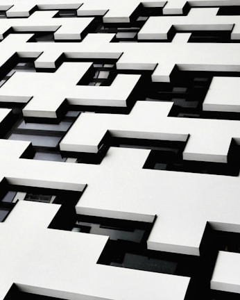 Elegant residential facade with geometric shapes and subtle beige accents.