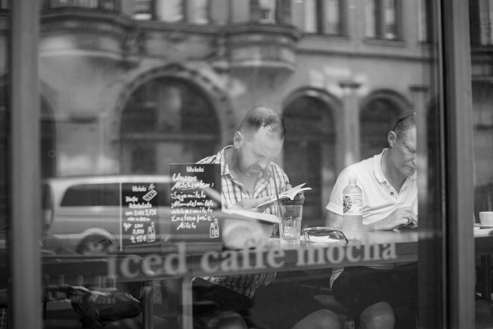 man reading books inside the building