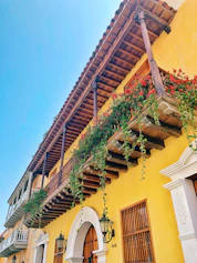 A renovated traditional Kerala house blending classic architecture with modern structural design and fresh yellow highlights.