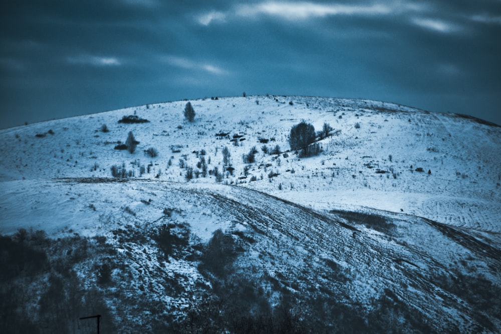 landscape photo of snow covered mountain under cloudy sky