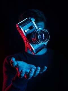 person holding DSLR camera