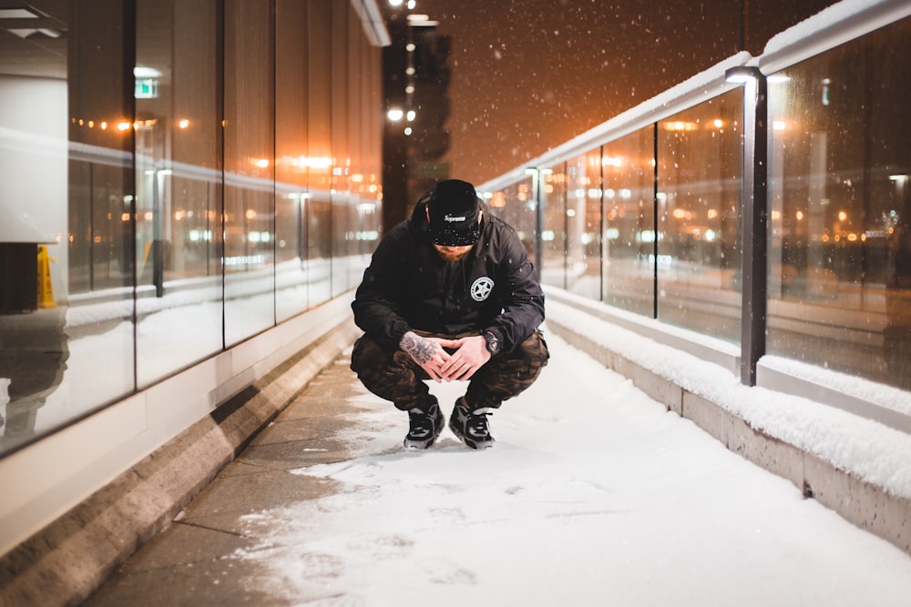 man squat on pavement