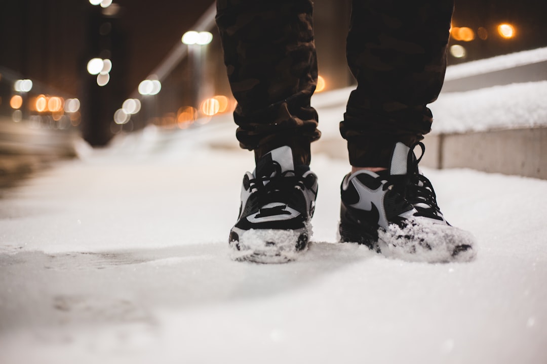 person wearing gray-and-black Nike shoes