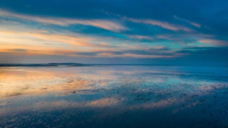 A serene Mediterranean coastal view at dusk with soft pastel skies over the French Riviera.