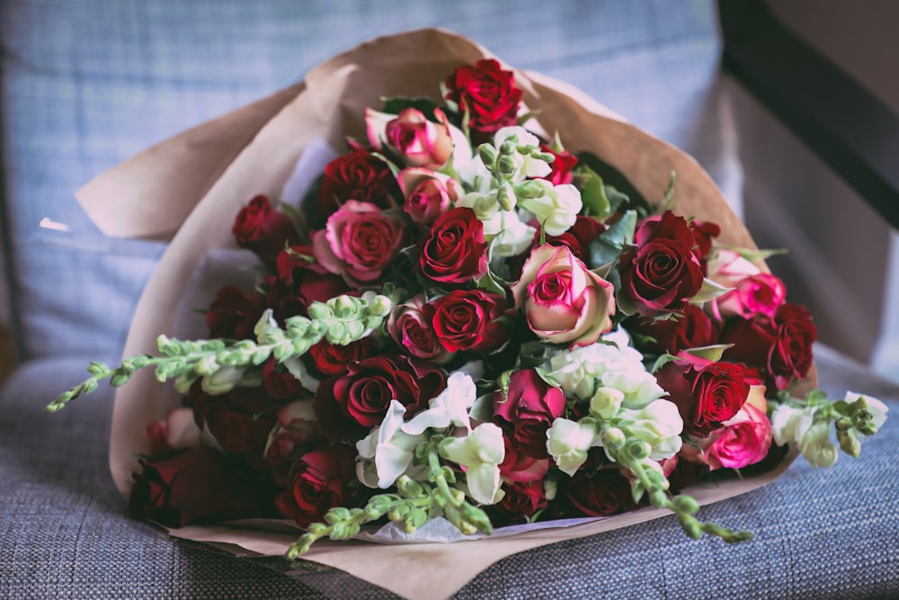 pink and red roses bouquet on chair