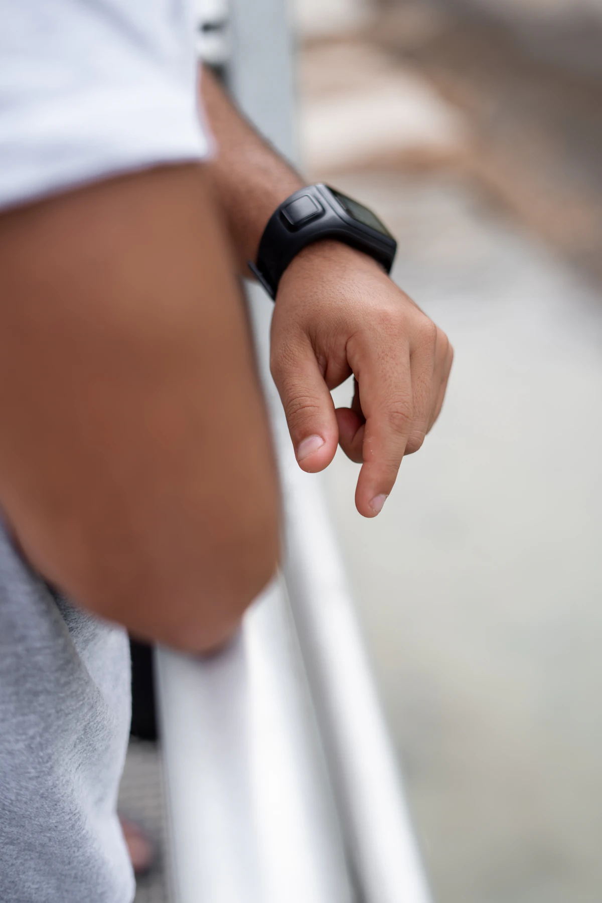 Man wearing a black smartwatch checking his heart rate, illustrating heart health monitoring on GLP-1 therapy.