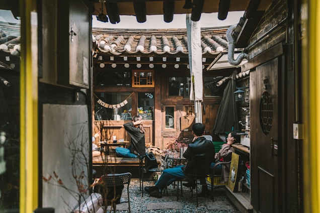 A group of property owners discussing plans in a cozy residential courtyard.