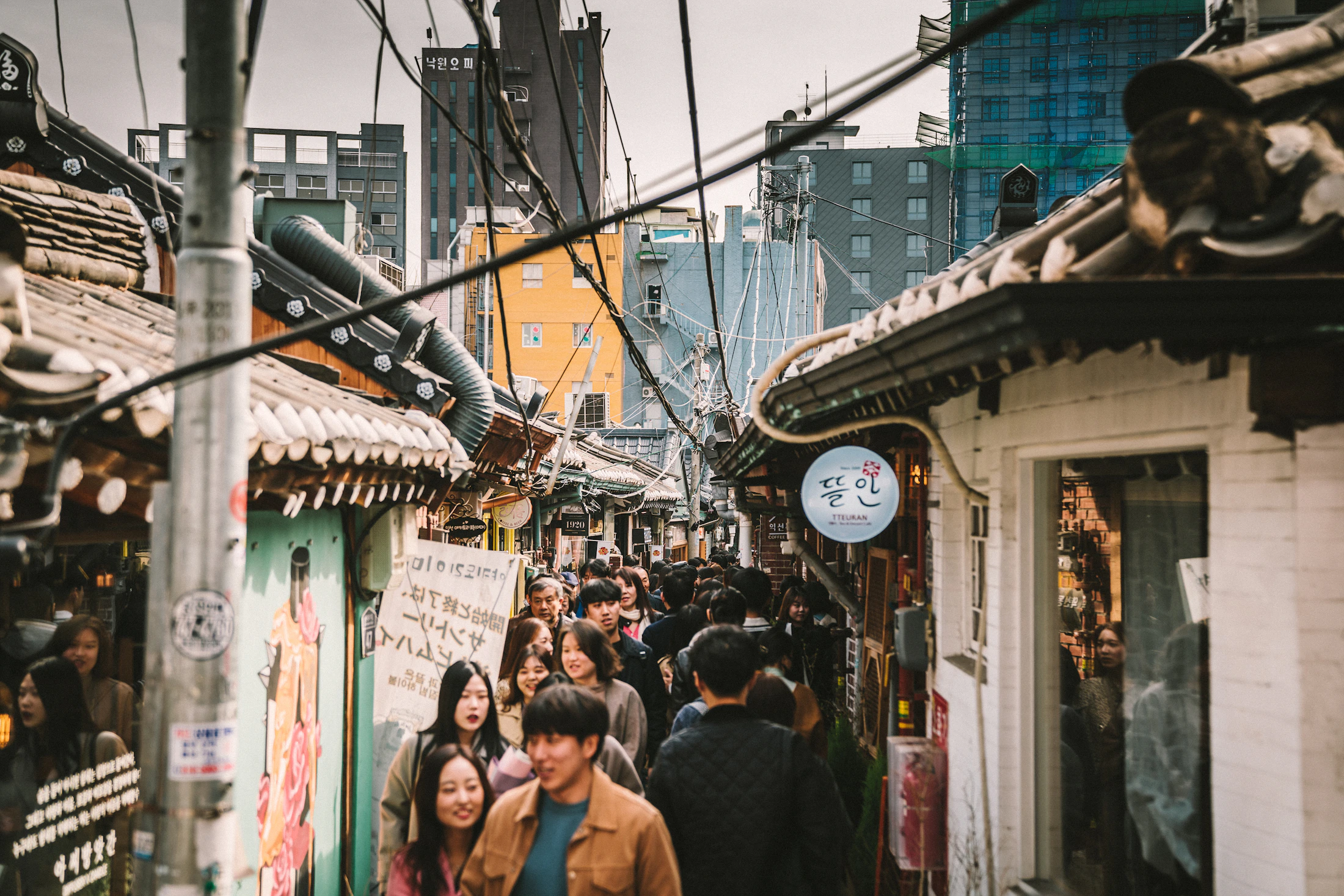 People moving through a commercial street in Seoul