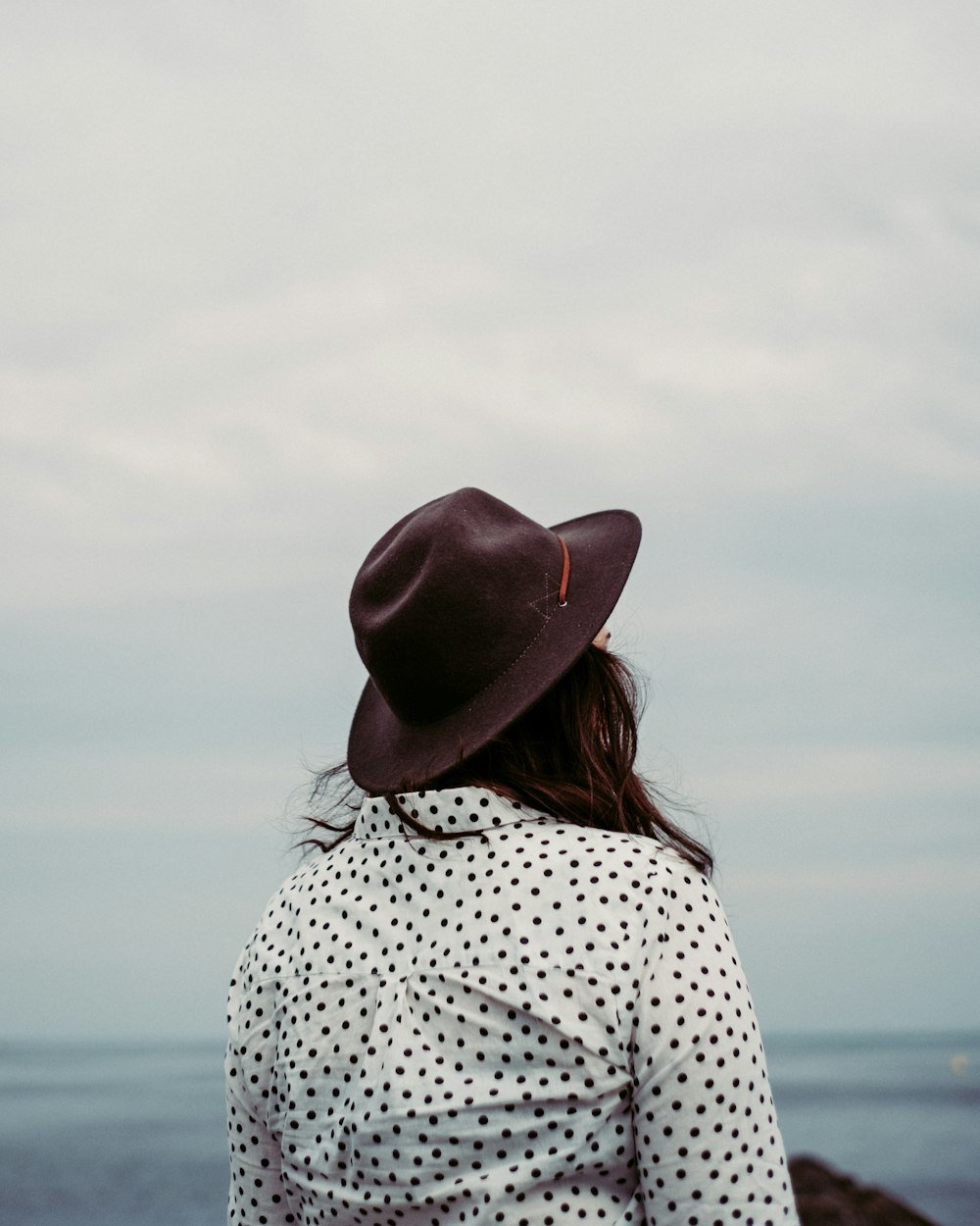 woman wearing brown hat